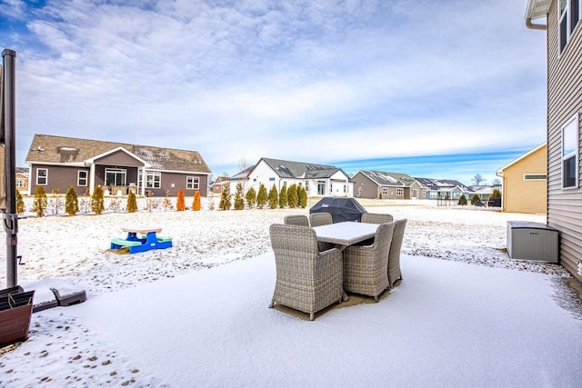 snow covered patio featuring outdoor dining area