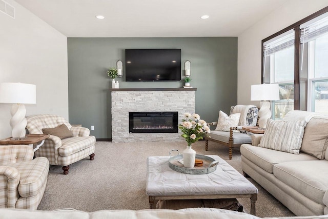 carpeted living room with baseboards, a fireplace, visible vents, and recessed lighting