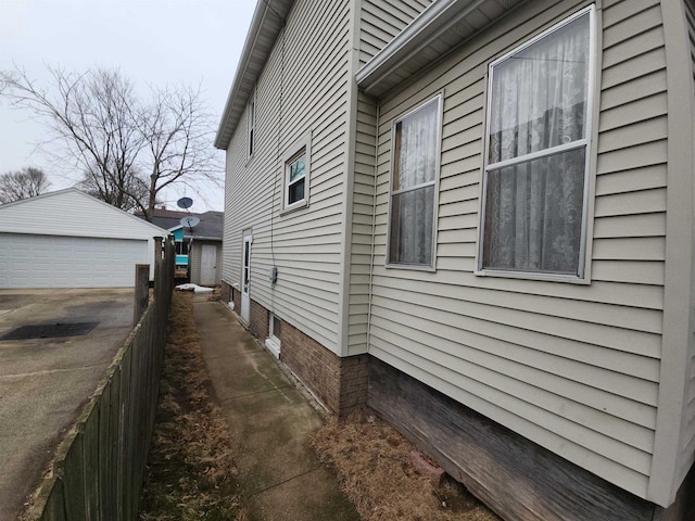 view of side of property with a garage and an outdoor structure