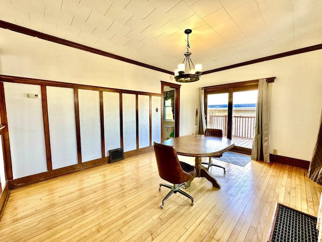 dining area with a chandelier, visible vents, baseboards, wood-type flooring, and crown molding