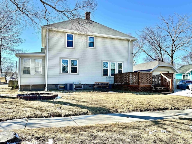 back of property featuring central air condition unit, a chimney, and a deck