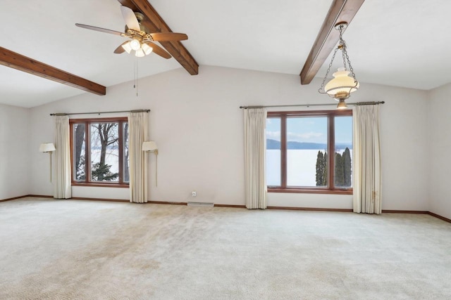 unfurnished room featuring carpet floors, lofted ceiling with beams, baseboards, and a ceiling fan