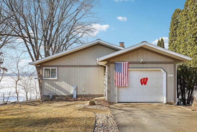 single story home featuring a garage and driveway