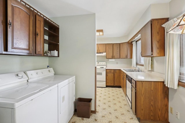 laundry area with washer and dryer, a sink, and light floors