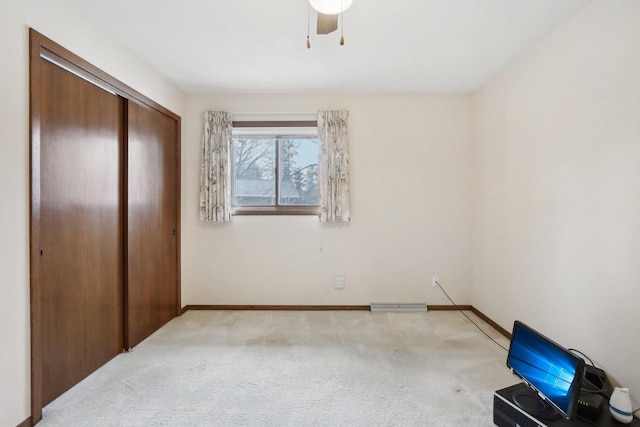 unfurnished bedroom featuring light carpet, a closet, and baseboards