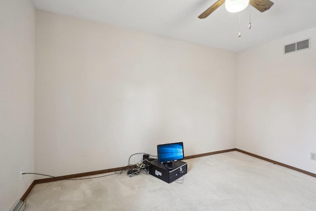 empty room featuring baseboards, visible vents, a ceiling fan, and light colored carpet