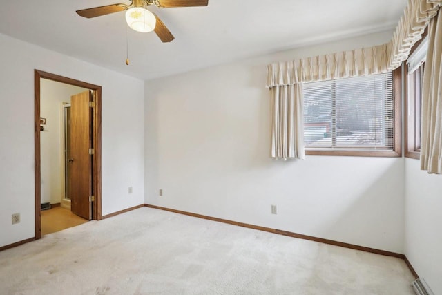 unfurnished bedroom with carpet, baseboards, ceiling fan, and ensuite bathroom