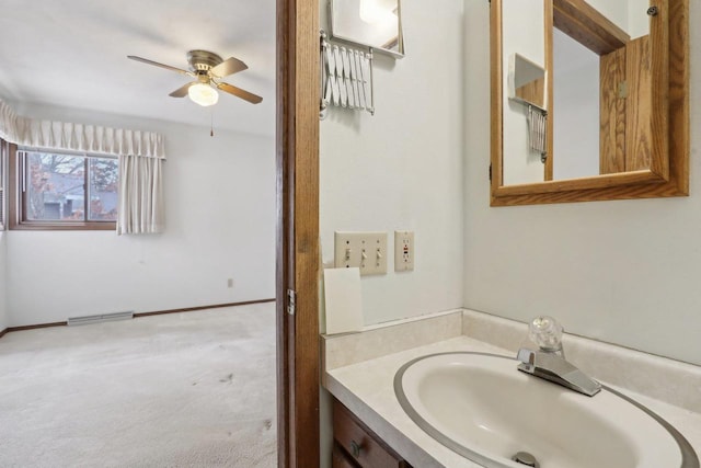 bathroom with ceiling fan, vanity, visible vents, and baseboards