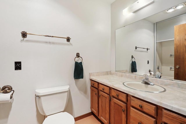 half bathroom with vanity and toilet