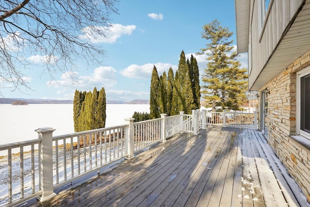 deck with a water and mountain view