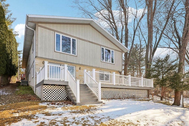 view of front of home with a wooden deck and central air condition unit