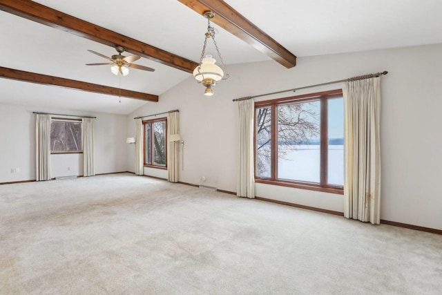 spare room with carpet floors, vaulted ceiling with beams, baseboards, and ceiling fan