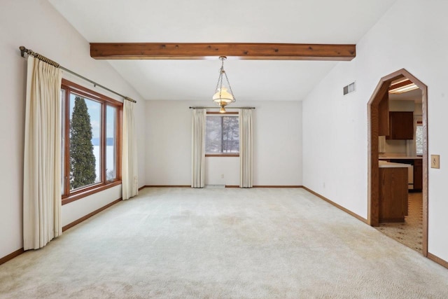 spare room featuring lofted ceiling with beams, arched walkways, light colored carpet, visible vents, and baseboards