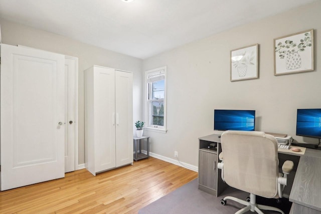 office area with light wood-type flooring and baseboards