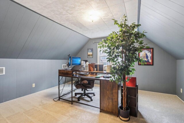 office space with lofted ceiling, carpet floors, and visible vents