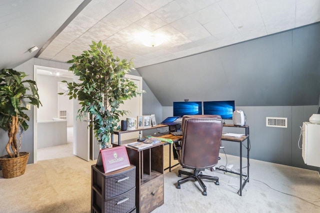 office with carpet, visible vents, and vaulted ceiling