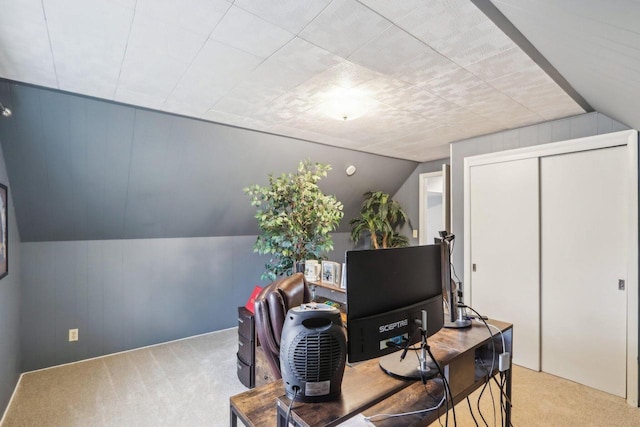 carpeted office space with lofted ceiling