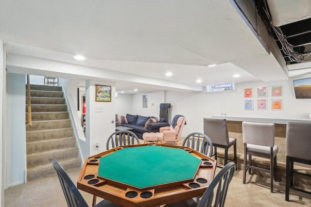 recreation room featuring a dry bar, light colored carpet, electric panel, and recessed lighting