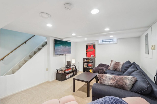 living area with recessed lighting, electric panel, light colored carpet, and stairs