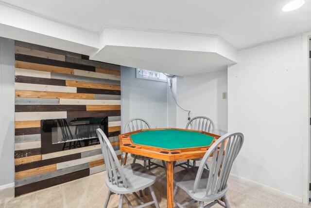 playroom featuring carpet floors, wood walls, and baseboards