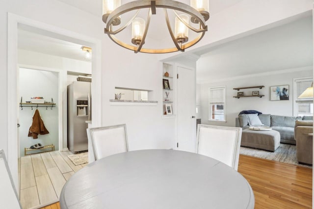 dining room with a chandelier and wood finished floors