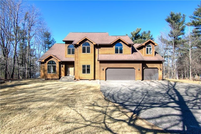 view of front of property with driveway and an attached garage