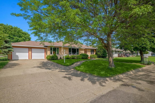 ranch-style house with an attached garage, driveway, and a front lawn