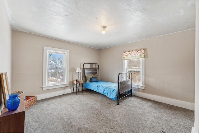 bedroom featuring carpet flooring and baseboards