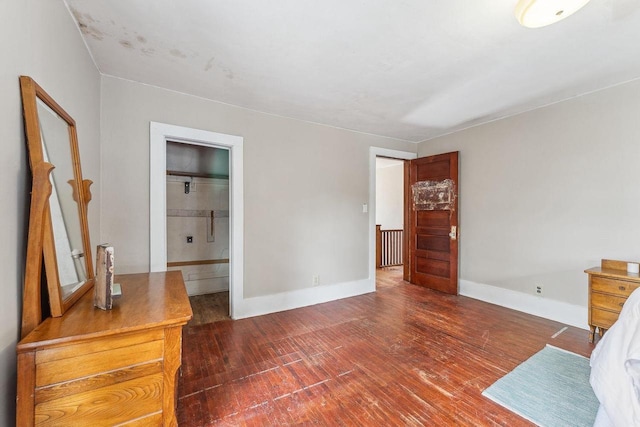 bedroom featuring baseboards and wood finished floors