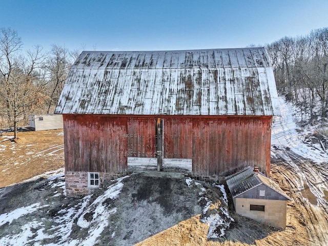 exterior space featuring a barn and an outbuilding