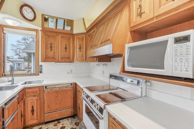 kitchen with white microwave, range with electric stovetop, a sink, light countertops, and dishwasher