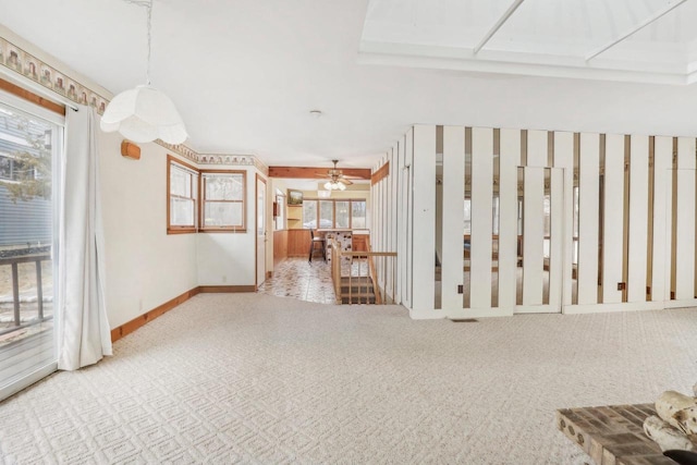 unfurnished living room with carpet flooring and baseboards