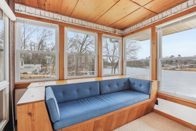 sunroom with wood ceiling and a healthy amount of sunlight