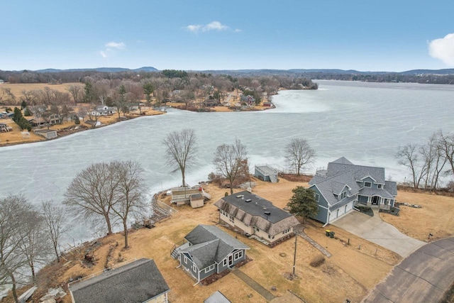 birds eye view of property with a water view