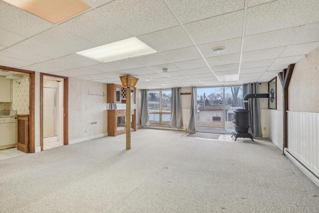 below grade area with carpet and a paneled ceiling