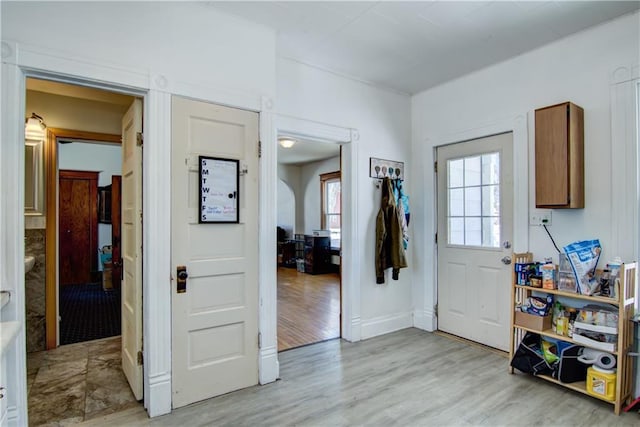 interior space with baseboards and light wood-style floors