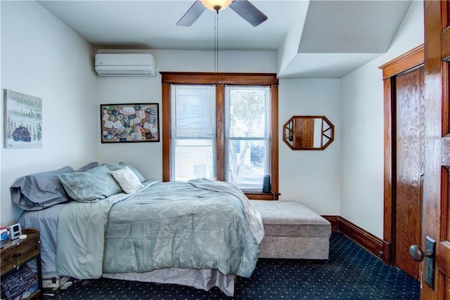 carpeted bedroom with ceiling fan, a wall unit AC, and baseboards