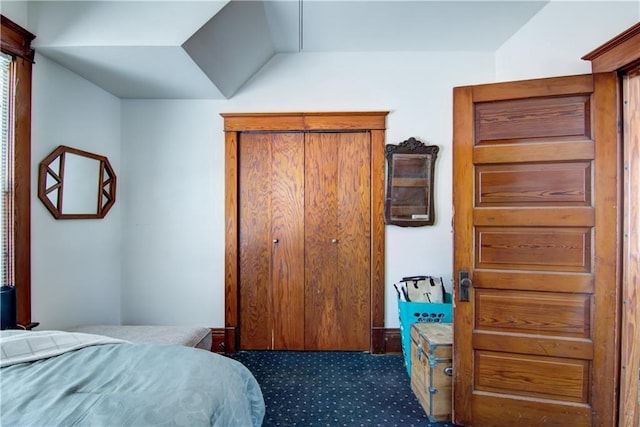 bedroom featuring dark carpet