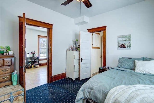 carpeted bedroom featuring ceiling fan and baseboards