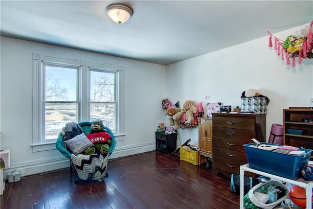 interior space with hardwood / wood-style floors, multiple windows, and baseboards