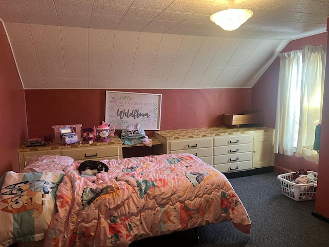 bedroom with dark colored carpet and lofted ceiling