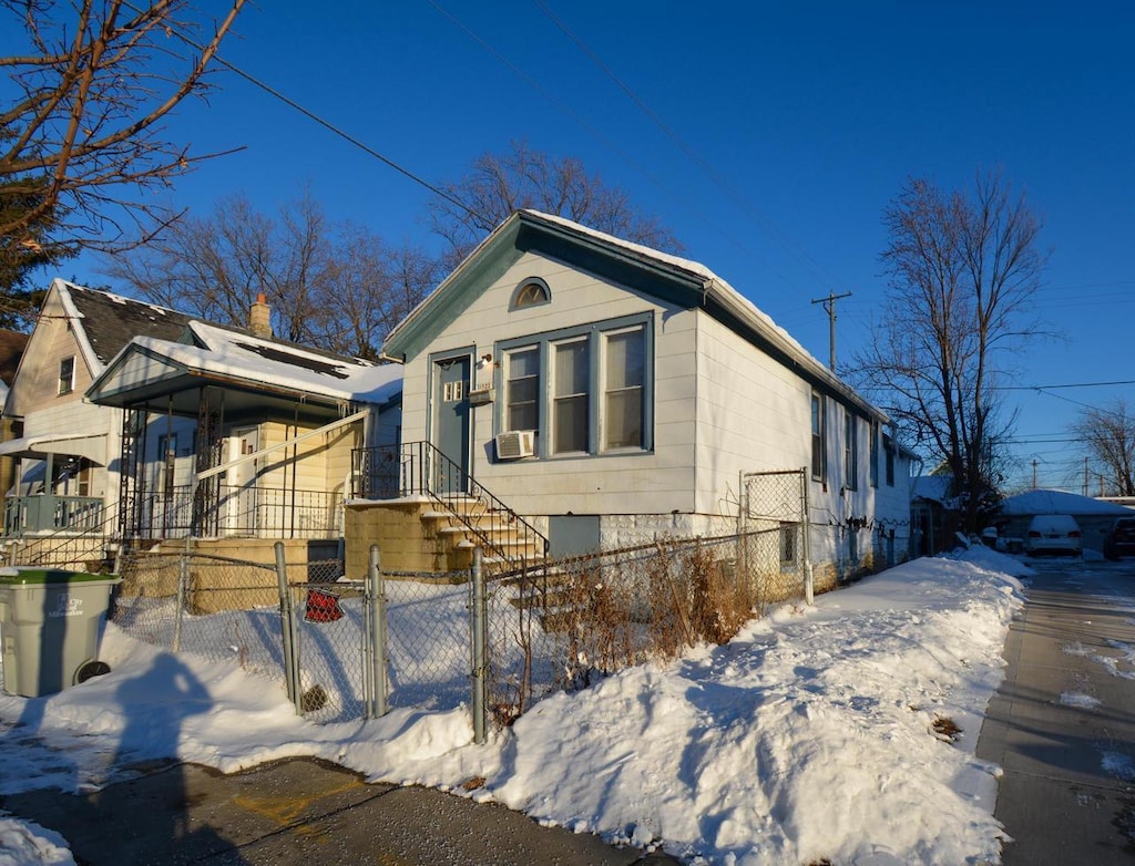 view of front of home with a fenced front yard and a gate