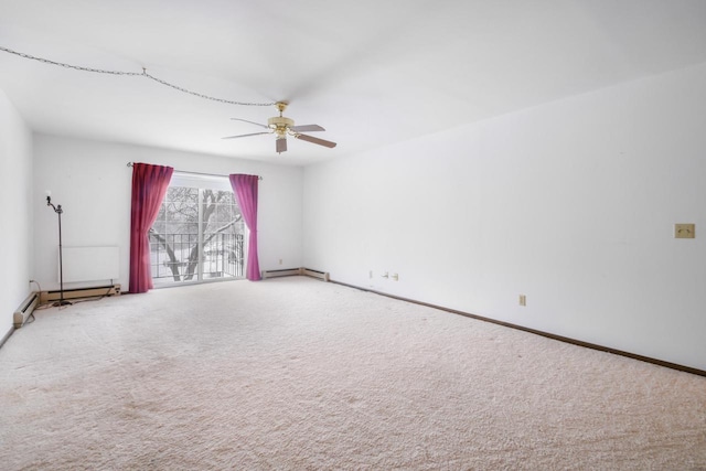 carpeted spare room with ceiling fan and a baseboard heating unit