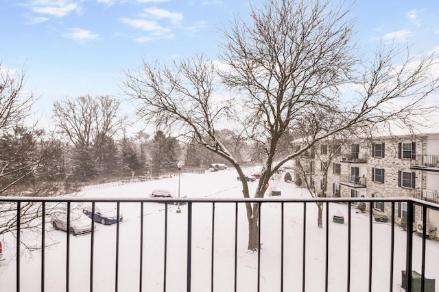 view of snow covered back of property