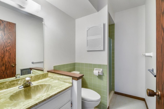 full bathroom with tile walls, toilet, vanity, tile patterned flooring, and walk in shower