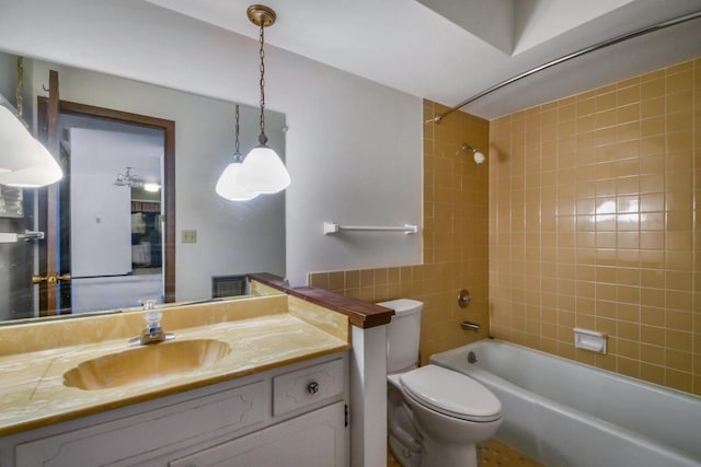 bathroom featuring shower / bathing tub combination, vanity, and toilet