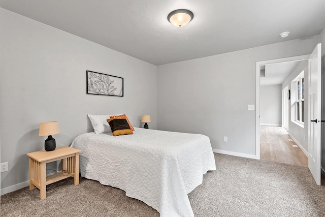 bedroom featuring carpet floors and baseboards