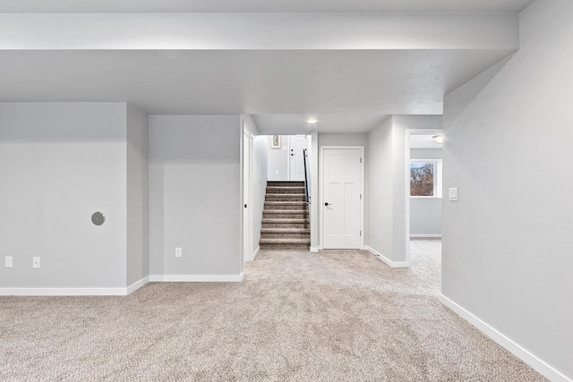 interior space featuring light carpet, stairway, and baseboards