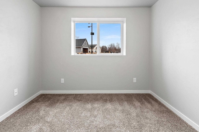 spare room with carpet floors and baseboards