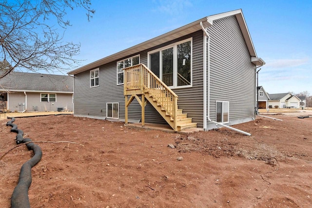 rear view of property featuring stairs